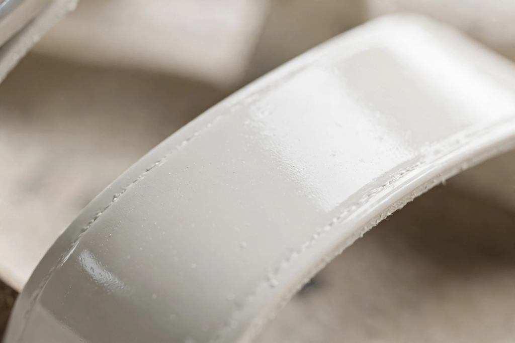 Close-up of a white patent Birko-Flor Birkenstock strap with a smooth, shiny finish