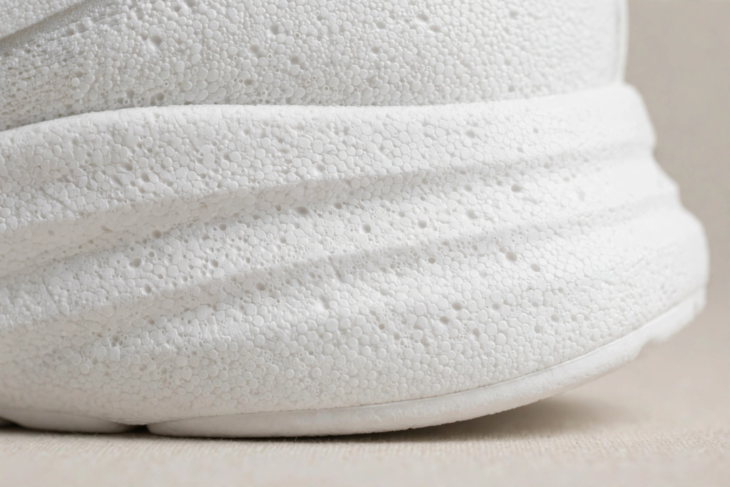 Close-up of a lightweight EVA foam shoe sole with porous cushioning texture